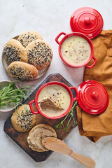 Gourmet Liver Pate Appetizer with Sesame Seed Bagels and and Fresh Pea Shoots on Rustic Wooden Board