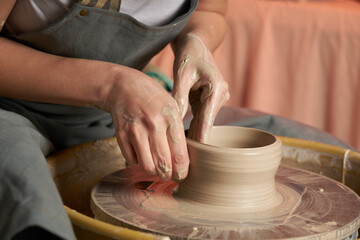 Pottery class. Hands hols clay on a  potter's wheel
