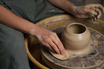 Pottery class. Hands hols clay on a  potter's wheel