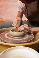 Pottery class. Hands hols clay on a  potter's wheel