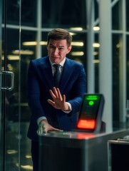 Stressed Employee at Biometric Scanner in Corporate Office