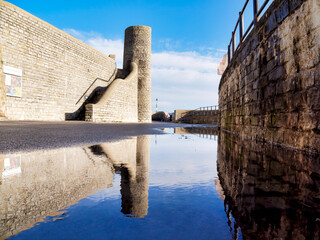 Puddle Reflections along Gun Cliff Walkway in Winter at Lyme Regis Dorset