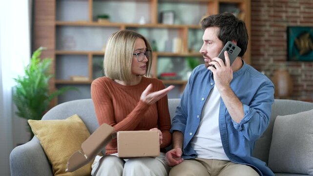 Dissatisfied married couple received a parcel with the wrong product while opening a package at home. Man arguing on phone giving bad feedback. Wife and husband make a negative review. Service issue