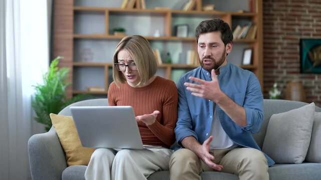 Sad married couple talking on video call with family psychologist using laptop sitting at home. Upset husband and wife complains to a psychotherapist about family problems, woman cries during session