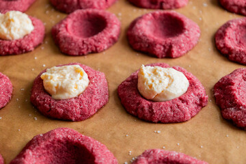 Filling Red Velvet Thumbprint Cookies with Cream Cheese in Tray
