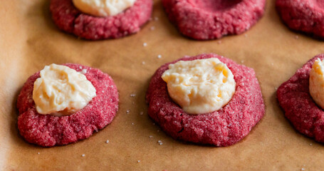 Filling Red Velvet Thumbprint Cookies with Cream Cheese in Tray