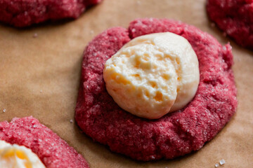 Filling Red Velvet Thumbprint Cookies with Cream Cheese in Tray