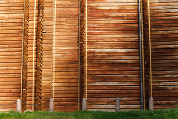 huge wooden wall of ancient golden gate Ukrainian historical exhibit from past time now ints museum external side background with security camera object
