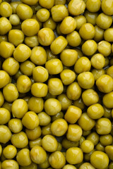 Fresh green peas background, texture of perfect peeled sweet pea grains as background. Vegetable background, vegetable protein, healthy products. Canned peas. spinning in a circle