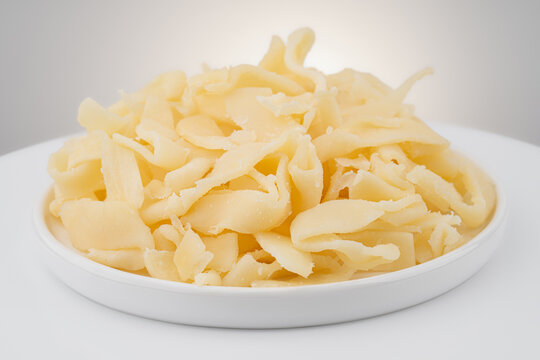 Beer snack made of dried squid. Dried squid isolated on white background. Dried squid shavings. Small fish, shrimp and squid that have been marinated with salt and dried