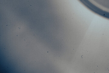 Abstract monochrome background featuring grainy texture, dust particles, scratches, and subtle light variations in black and white tones. Aged analog aesthetics create a gritty, distressed atmosphere 