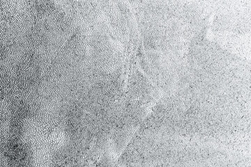 Monochrome grunge overlay with dusty texture, subtle grain, and organic surface details in black and white tones. The abstract material suggests aged paper or rough texture, creating a raw, atmospheri