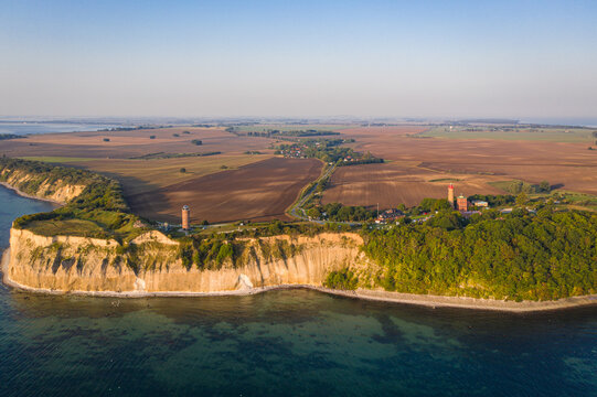Aerial view of chalk cliffs meet the sea near the Kap Arkona lighthouse, where golden light kisses the landscape, Putgarten, Mecklenburg-Vorpommern, Germany.
