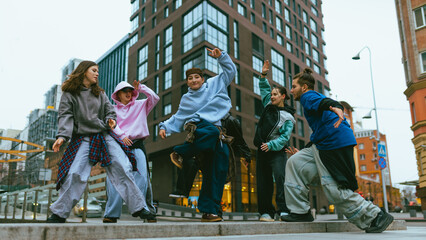 Hip hop dancers practicing freestyle routine on modern city square. Concept of youth self expression, street fashion showcase, active leisure, urban culture content, social media promotion. © Lustre Art Group 