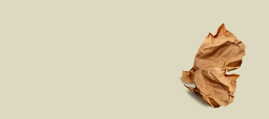 Brown paper, paper scrap, isolated. Modern abstract artistic image. Sustainable packaging, sustainable use of materials, crumpled used paper. Minimalist paper wallpaper