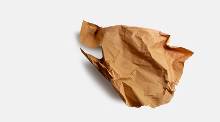 Brown paper, paper scrap, isolated. Modern abstract artistic image. Sustainable packaging, sustainable use of materials, crumpled used paper. Minimalist paper wallpaper