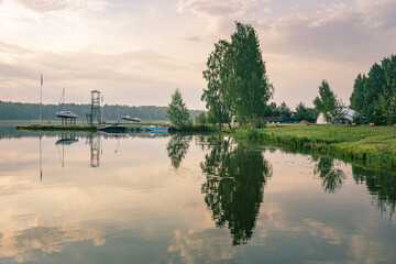 Fototapeta premium Lake with a few boats and a tree in the background