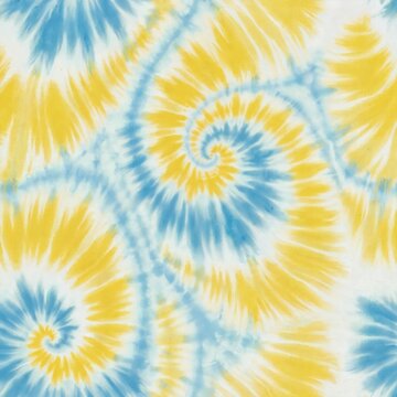 Blue and yellow pastel swirl tie dye pattern. Psychedelic groovy pattern repeats across fabric. Boho ink stain design creates retro fashion vibe.