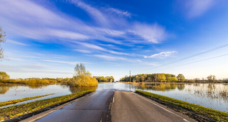 Road is flooded with water and the sky is blue