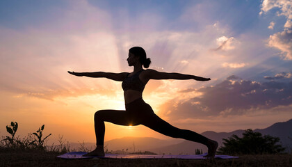 Silhouette of Woman Practicing Yoga Warrior Pose at Sunrise with Mountain Landscape.