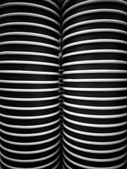 Close-up of neatly stacked disposable coffee cups forming a clean geometric pattern and symmetrical lines in a monochrome modern design suitable for backgrounds or textures.