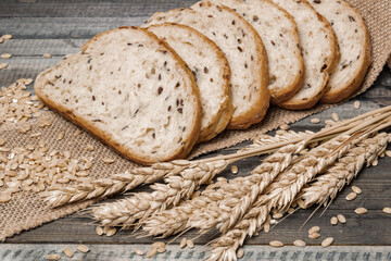 Whole grain and seeds sliced bread. Fresh bakery products. Design a poster for a kitchen or bakery.