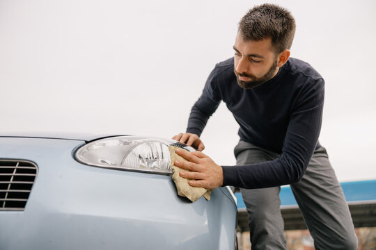 Manual car washing service outdoors in urban area