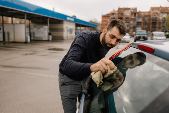 Professional car wash service cleaning vehicle glass