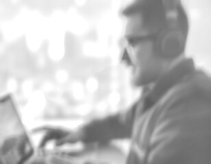 The blurry, black and white image of using technology.