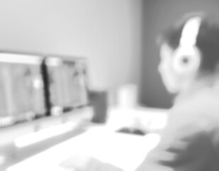 The blurred, black and white image of using technology.
