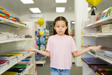 Confused girl feeling indecisive choosing school supplies for back to school