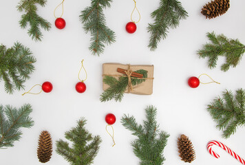 Christmas flat lay styled scene with evergreen fir tree, decorations and present box