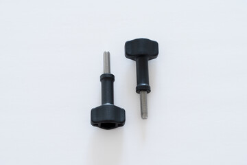 Two Black-head thumb screws placed opposite on white background