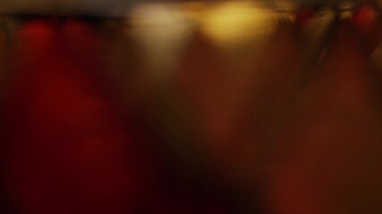 Abstract dark red and gold bokeh light leaks moving in the background creating a cinematic and elegant atmosphere for holidays or luxury video overlays - Powered by Adobe