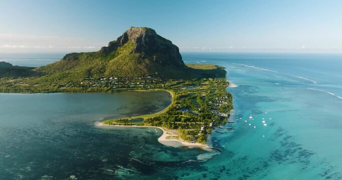 Aerial view of the striking Le Morne Brabant mountain, with its lush green slopes contrasting against the turquoise waters, Le Morne, Mauritius.