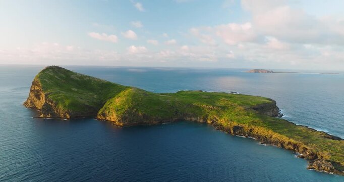 Aerial view of Coin de Mire island showing the contrast between the deep blue sea and the lush green island, Coin de Mire, Mauritius.