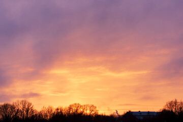 Stunning natural phenomenon: Golden hour sky in fiery orange and vibrant violet tones