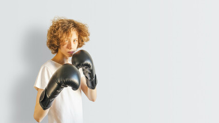 Teen Boxer With Gloves Posing Against Neutral Wall For Youth Sports Promotion, Boxing School Advertising, Teen Fitness Campaigns And Empowerment Visuals Focused On Active Healthy Lifestyle