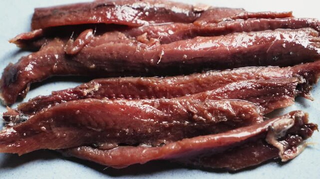 Close-up of anchovy fillet, Cantabrian anchovies in olive oil are the perfect appetizer for wine and vermouth in Spain. High quality 4k footage