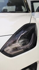 detailed headlight design, sleek modern style, sharp angular lines, intricate details, glossy finish