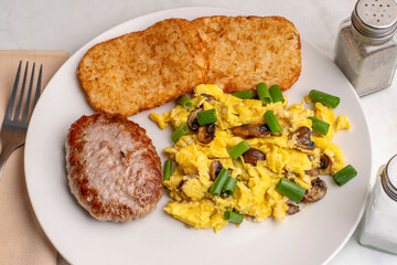 scramble eggs with hash browns and sausage patty