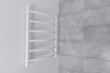 Modern White Towel Warmer Mounted on a Sleek Grey Tiled Bathroom Wall for Efficient Drying and Elegant Design
