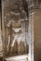Bas relief carving of a jackal in a toga on the wall of a burial chamber in the Catacombs of Kom el Shoqafa in Alexandria, Egypt