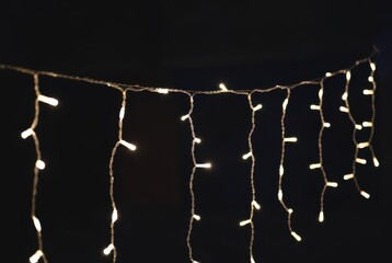 Close-up of warm white led fairy string lights glowing softly, perfect for festive decor.