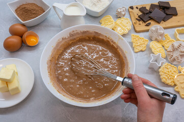 Woman preparing dough for Christmas cookies. The process of making Christmas pastries. Top view.