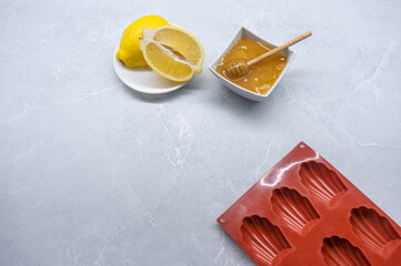 Madeleine mold and ingredients on a marble table. Top View. Space for Text.