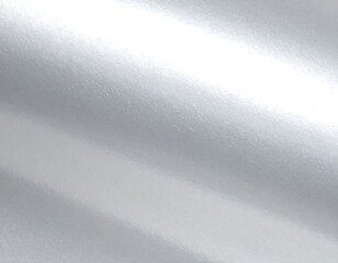 Close-up of glossy, reflective surface with diagonal streaks of bright light and varying shades of gray, resembling smooth metal