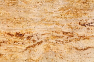 Real stone background. Golden beige travertine natural stone texture background for use on ceramic tiles or as digital background.