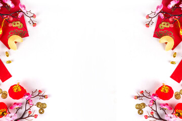 Bright vibrant gold and red Chinese New Year background with mandarin oranges, blossom tree branches, decorative fans, festive greeting envelops and coins, traditional Chinese New Year ornaments