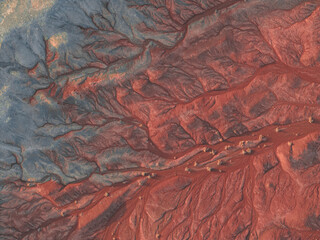 Naklejka premium Eroded Patterns of Painted Earth-Earth’s Wrinkled Tapestry in Arid Hues-Textured Terrains: Hues of Dusk in Arid Lands